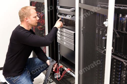 Man Working with Server Hardware in Data Center