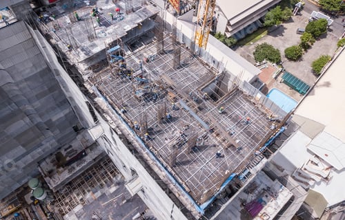 Preview: Aerial view of busy industrial construction site workers working. Development high rise building.
