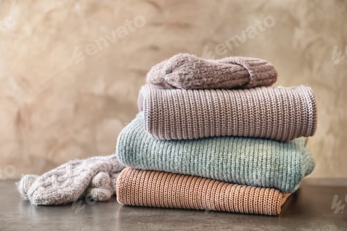 Preview: Stack of warm knitted clothes on table