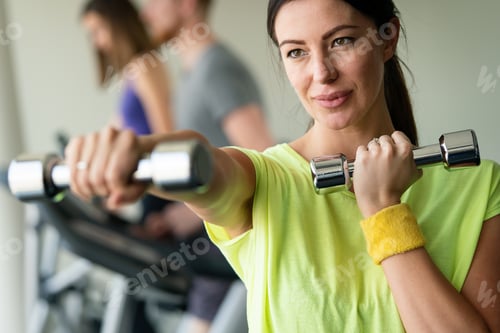 Preview: Portrait of attractive fit woman in gym