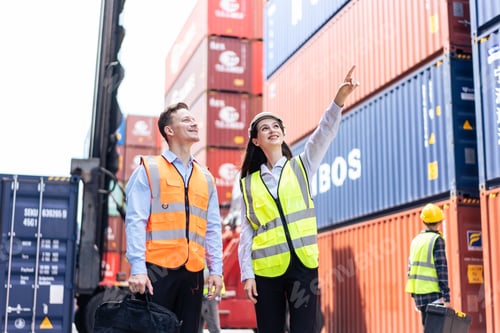 Preview: Caucasian business man and woman worker working in container terminal.