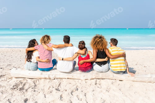 Preview: Friends taking a break, sitting on the beach