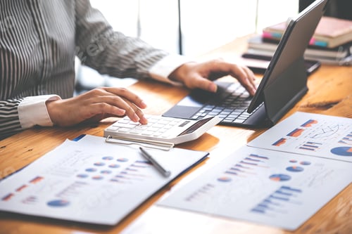 Preview: businessman or accountant who are using a calculator to calculate business data Accounting documents