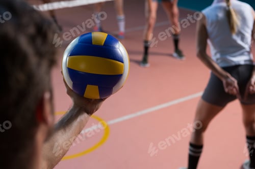Preview: Cropped hand of player holding volleyball by female teammate
