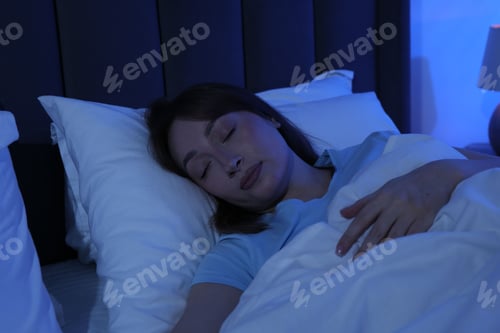 Preview: Beautiful woman sleeping in bed at home