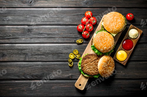Preview: Burgers with different sauces,jalapenos and tomatoes.