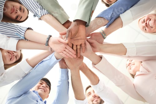 Preview: People putting hands together on light background, bottom view. Unity concept