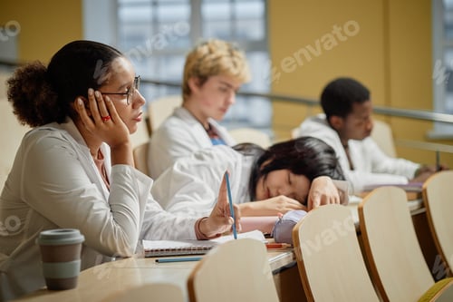 Preview: Young Asian Girl Sleeping on Desk in Lecture