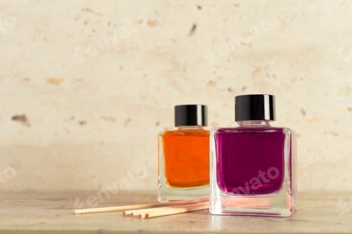 Preview: Colorful nail polishes and wooden sticks arranged on a simple surface