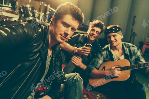 Preview: selective focus of stylish man taking selfie with happy friends