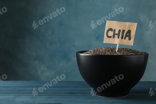 Preview: Black bowl and word Chia on wooden background, copy space