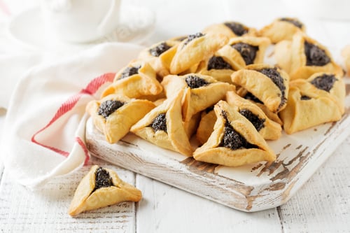 Preview: Traditional Jewish Hamantaschen cookies with berry jam. Purim celebration concept. Jewish carnival h