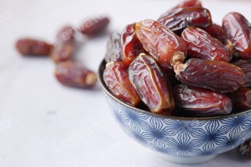 Preview: close up of fresh date fruit in a bowl on table