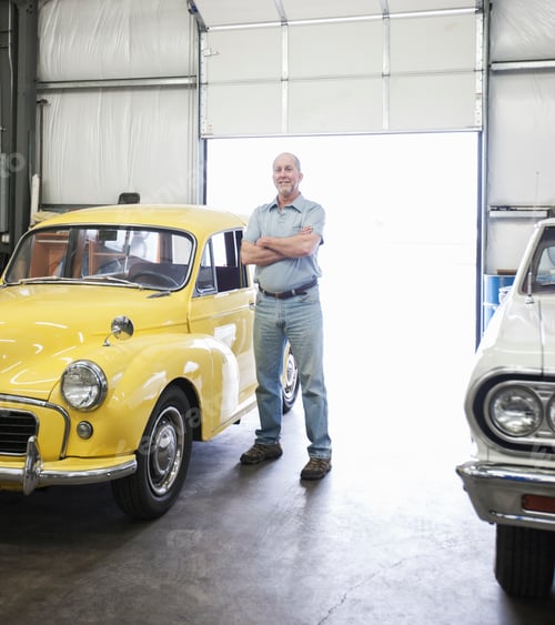 Preview: Portrait of a senior caucasian male owner of an antique car repair shop
