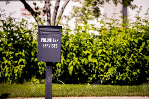 Preview: Closeup shot of a mailbox with volunteer service written on it and a blurred background