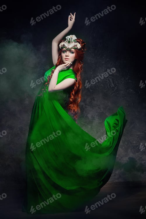 Preview: Redhead girl fabulous look, green long dress, bright makeup and big eyelashes. Mysterious fairy