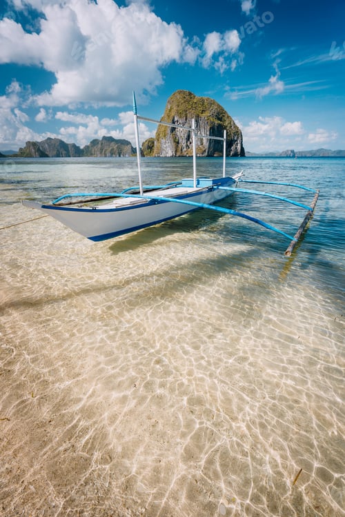 Preview: Cloudscape above picturesque lagoon with boat in El Nido, Palawan, Philippines. Unique places