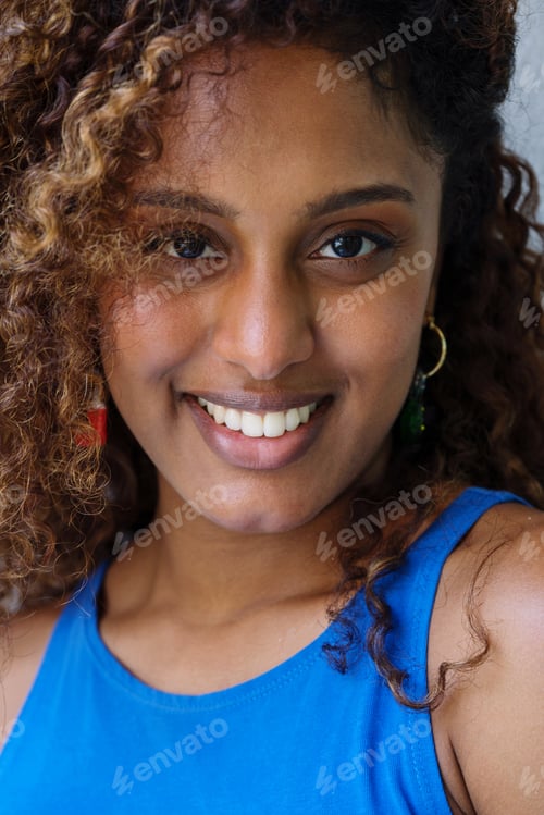 Preview: Beautiful black woman with curly hair wearing Christmas earrings