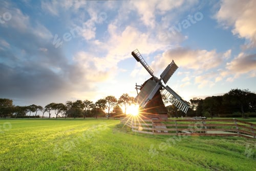 Preview: sunrise behind beautiful Dutch windmill