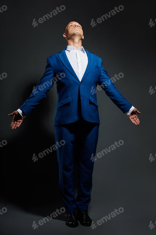 Preview: Contrast portrait of a man businessman in an expensive business suit on a dark background