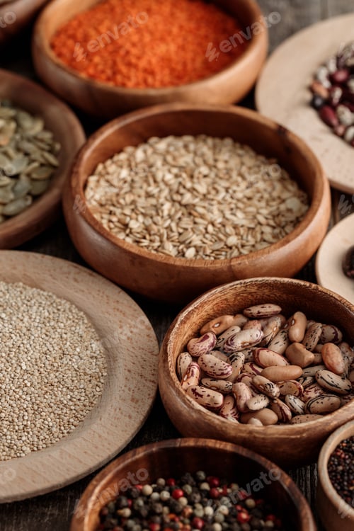 Preview: diverse wooden bowls with beans, pumpkin seeds, lentil and cereals