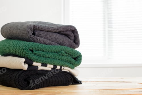 Preview: Stack of white cozy knitted sweaters