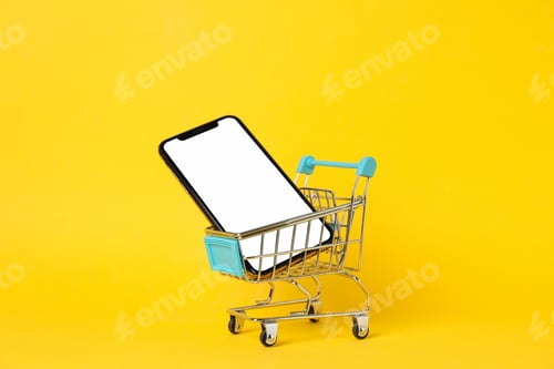 Preview: Phone with empty screen and shopping cart on yellow background, close up