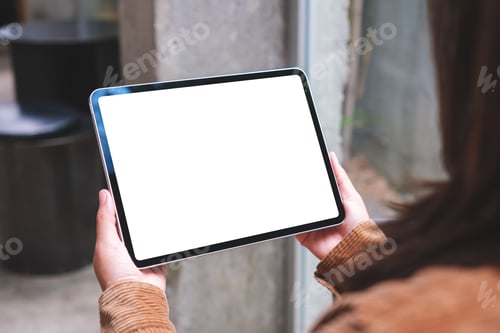 Preview: Mockup image of a woman holding digital tablet with blank white desktop screen in cafe