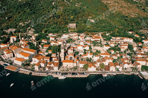 Preview: Cars are parked near the Church of St. Nicholas on the seashore. Perast, Montenegro. Drone