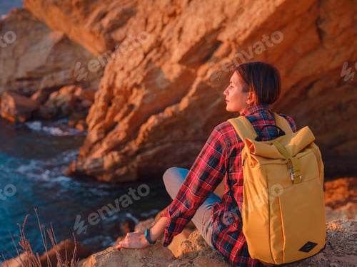 Preview: Young woman hiking on rocky beach in Spain, Benidorm