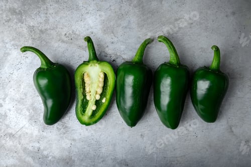 Preview: Green mexican jalapeno hot peppers on metal sheet