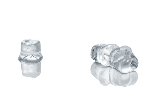 Preview: Piece of ice cubes melting on white glass table
