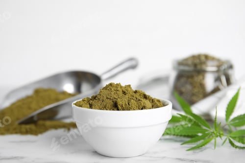 Preview: Hemp protein powder and fresh leaves on white marble table, closeup