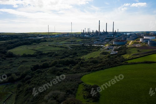 Preview: Aerial shot of an oil refinery industrial site with a forest around the coast of England