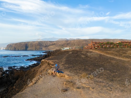 Preview: Drone view of the south coast of Tenerife with a drone pilot controlling the equipment