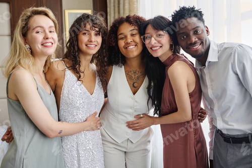 Preview: Intercultural group of wedding guests surrounding newlyweds in white attire