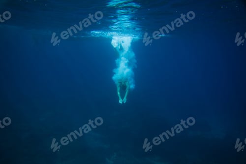 Preview: partial view of man diving into ocean