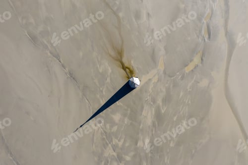 Preview: Aerial view of a church tower with cross, buried under mud and mining residuals