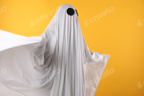 Preview: Creepy ghost. Person covered with white sheet on yellow background, space for text
