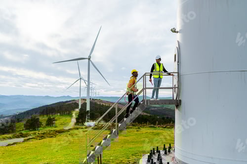 Preview: Engineer and operator inspecting wind turbine for renewable energy generation