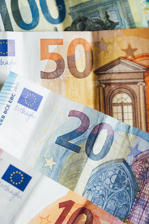 Preview: Vertical closeup shot of Euro bills spread on the surface