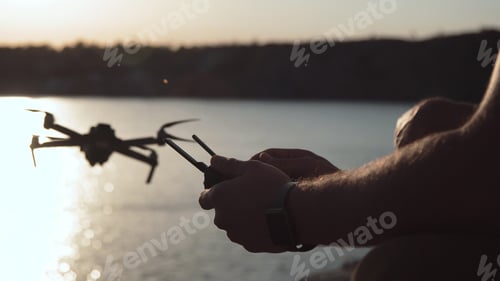 Preview: Movement Stabilized Crop Shot Of Man Hands Holding Remote Controller And Using Quad Copter On