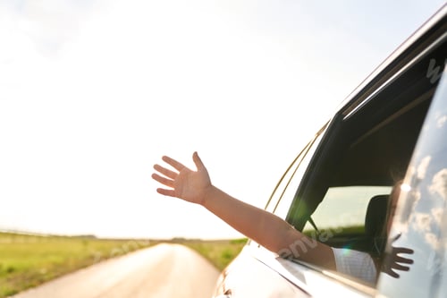 Preview: Unrecognizable child showing hand out of running car