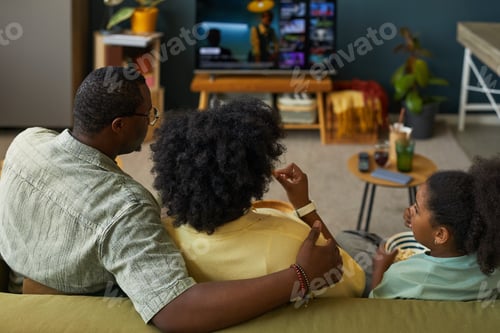Preview: Black Family Relaxing Together Watching Television in Living Room at Home