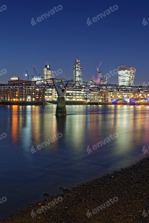Preview: UK, London, skyline with office towers and Millenium Bridge at night