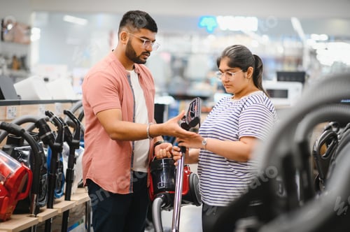 Preview: Indian Couple choosing vacuum cleaner, electronics store