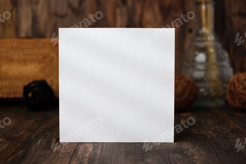 Preview: mockup square paper card on wood table and decor with wicker decoration items.