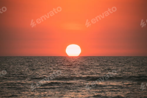Preview: Natural Color Sunset Sunrise Sky Over Sea. Seascape With Shining Setting Sun On Sea Horizon