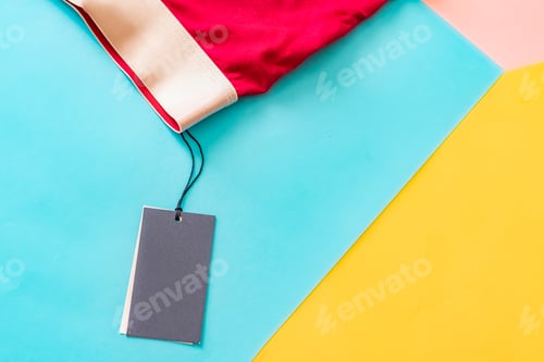 Preview: flat lay of new male red underwear pants isolated with blank price tag on creative color background
