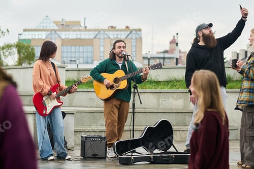 Preview: Multiethnic Young Adults Performing Live Music Outdoors during Street Event